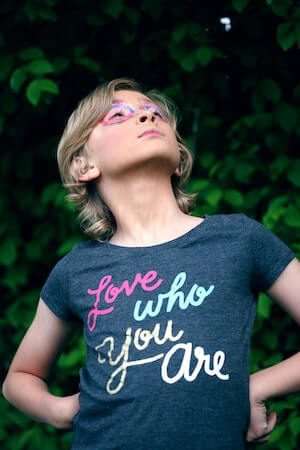 kid with shirt that says love who you are