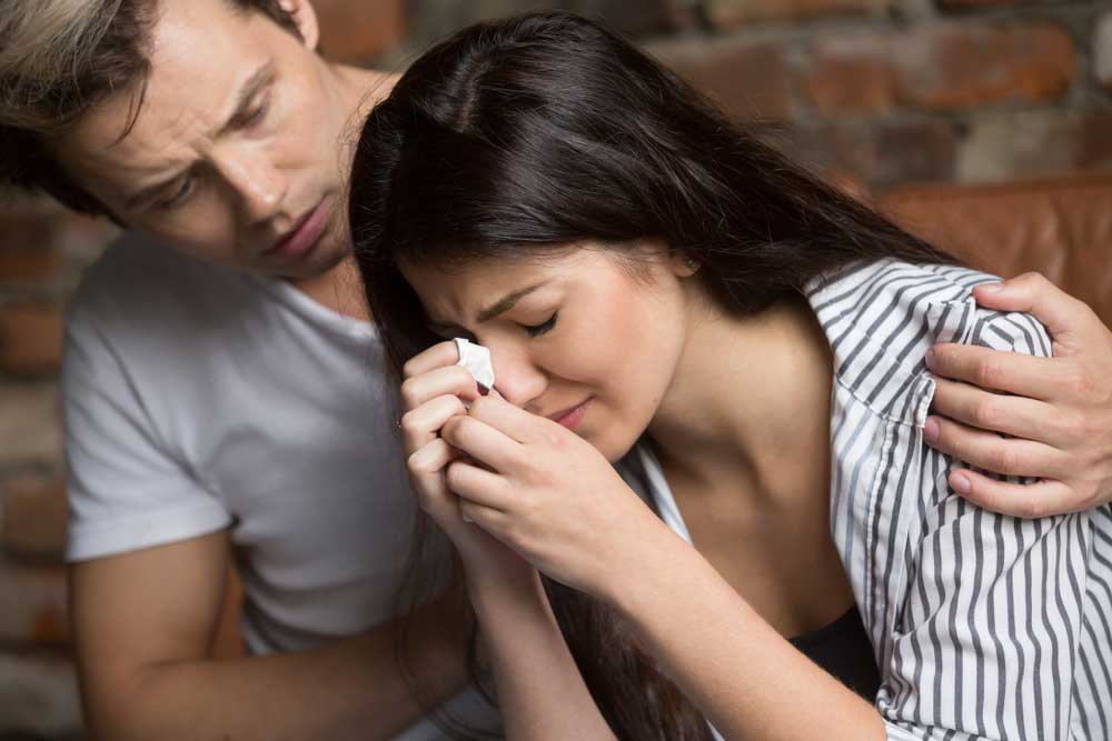 Husband helping wife overcome grief