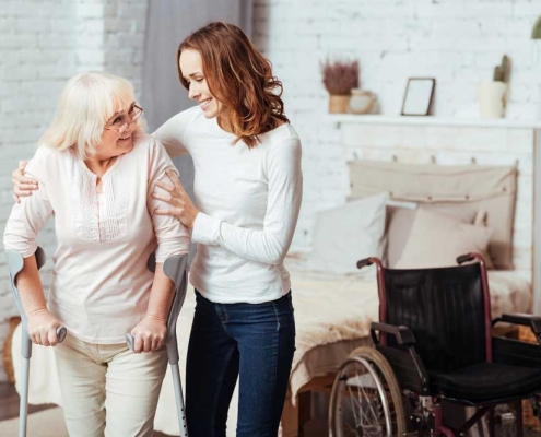 Caring Women Helping Her Grandmother To Walk